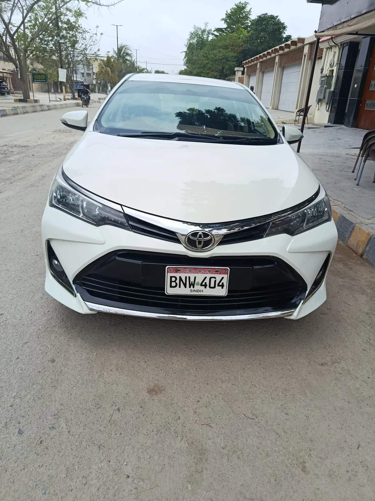 MK Rent A Car's white Toyota Corolla Altis X, plate BNW-404, parked on a Clifton street